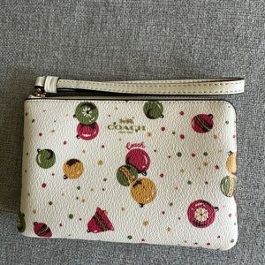Coach Cream Wristlet with Christmas Ornament Print